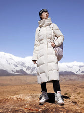 A lady wears a down jacket and black pants.